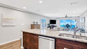 A modern kitchen with granite countertops, stainless steel appliances, and a built-in dishwasher. - Big 'O Beach Miramar/Destin (Miramar Beach)