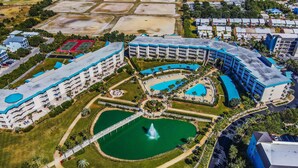 A large hotel complex with multiple buildings, a central courtyard with a fountain, and a swimming pool. - Big 'O Beach Miramar/Destin (Miramar Beach)