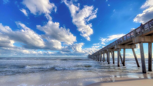 A pier extending into the ocean with a clear sky and clouds. - Lakefront, ground-floor condo with pools & hot tubs - walk to the beach (Panama City Beach)