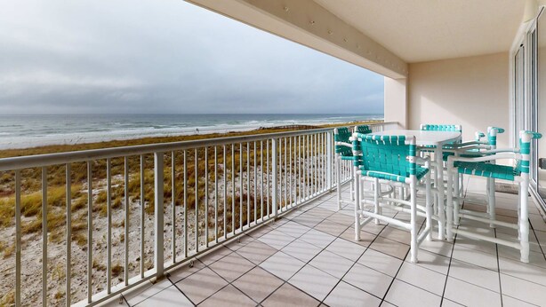 A balcony with a view of the beach and ocean. - Waterfront Condo with Balcony, Washer/Dryer & Shared Pool (Navarre Beach)