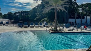 A swimming pool with lounge chairs and a palm tree. - Beautiful gem at Bayou Village, golf cart, WiFi, & resort pools (Miramar Beach)