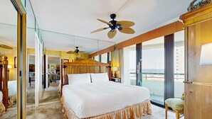 A spacious hotel room with a large bed, a ceiling fan, and a view of the ocean. - Gulf-view resort condo with pools, hot tubs, balcony, WiFi, W&D, & AC (Miramar Beach)
