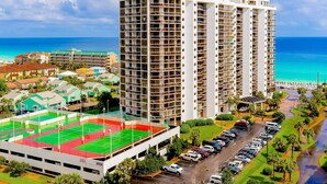 A multi-story hotel with a rooftop pool, adjacent to a beach. - This cozy and bright resort studio is perfect for a beach getaway. (Miramar Beach)