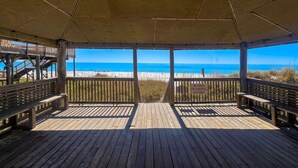 A wooden deck with a view of the beach. - Quaint Miramar Beach home with loft, pool, patio, full kitchen, & washer/dryer (Miramar Beach)