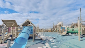 A playground with a blue slide, climbing structures, and a covered seating area. - Walk to Shore! Family Haven w/ Pool in Ocean City (Ocean City)