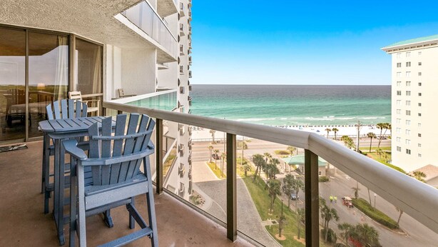 A balcony with a view of the ocean and a cityscape. - Beautiful condo w/ shared pool, hot tub, tennis, gym & gorgeous beach views (Miramar Beach)