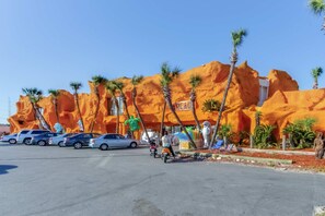 A parking lot with several cars and a motorbike. - 14th-floor oceanfront condo with ocean view, pool & hot tub access, WiFi, & W&D (Panama City Beach)