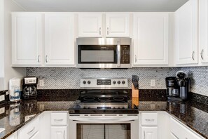 Fridge, microwave, oven, stovetop - Gulf-front condo with beautiful sunset views, pool, tiki bar, fitness room & W&D (Panama City Beach)