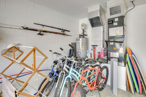 A room with bicycles, fishing rods, and a water heater. - Stroll to Shore: Pet-friendly Flagler Beach Escape (Flagler Beach)
