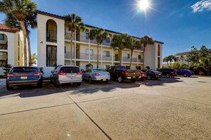 A multi-story hotel with a parking lot. - Beachfront Corner Condo with Free WiFi, Stunning Gulf View, & a Shared Pool (Santa Rosa Beach)