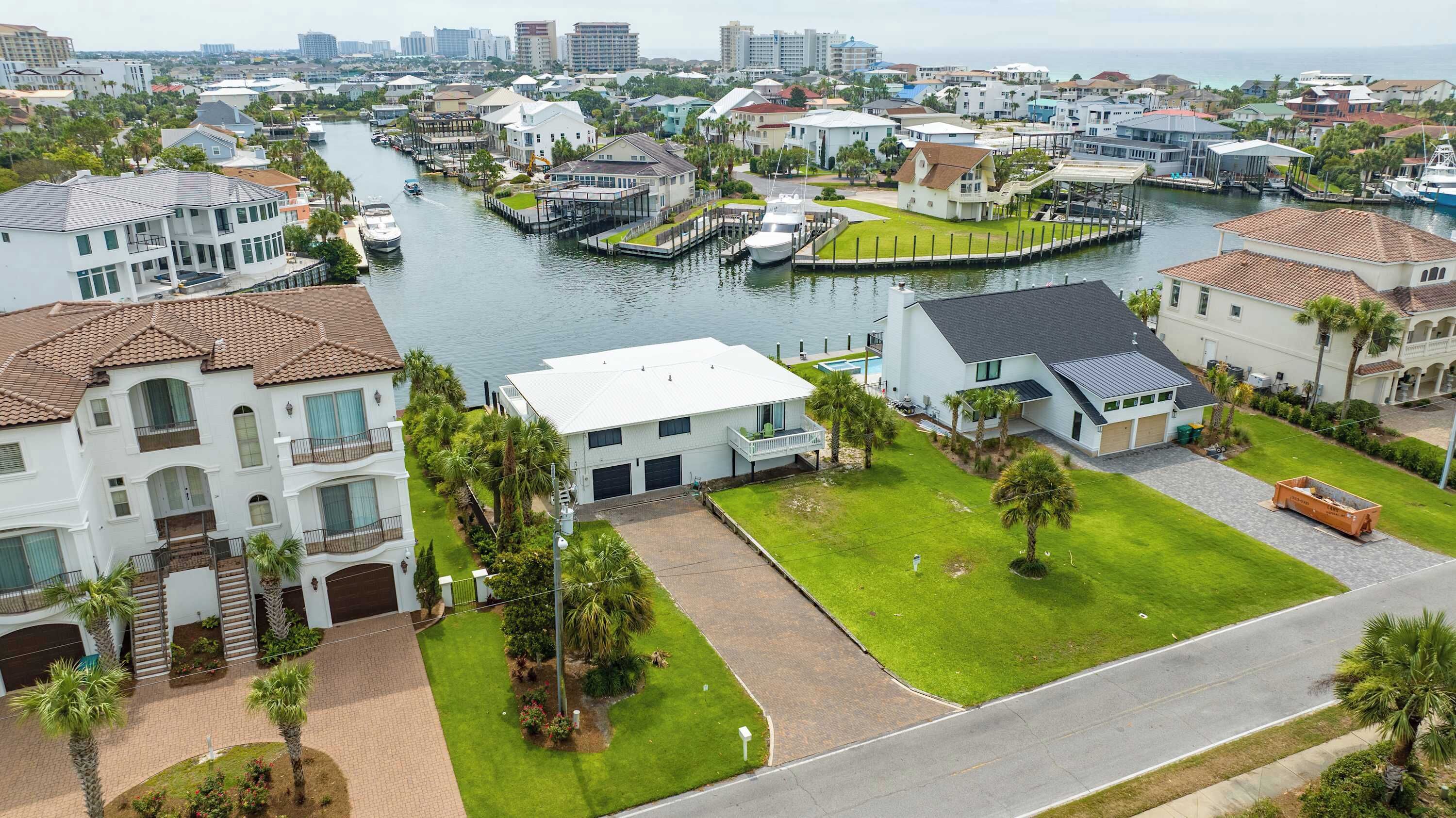 A residential area with houses, a marina, and a river.