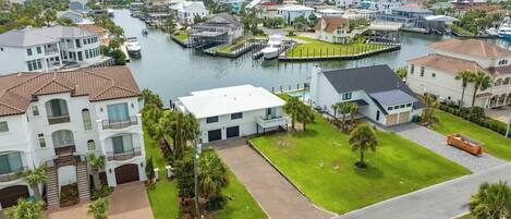 A residential area with houses, a marina, and a river.