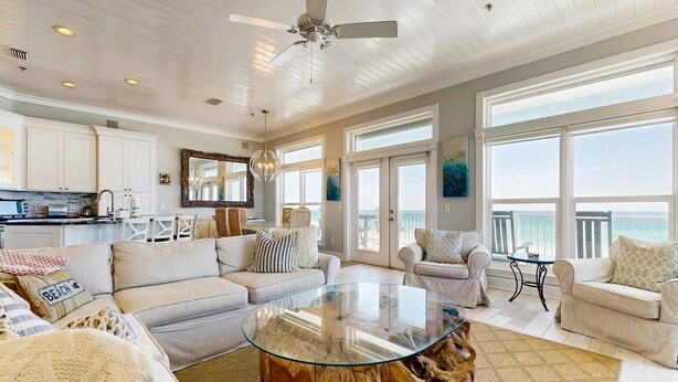 A spacious living area with a glass coffee table, white sofas, and a view of the ocean. - Gorgeous gulf-front condo, shared outdoor pool  - beach service included (Santa Rosa Beach)