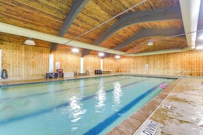 An indoor swimming pool with wooden walls and ceiling, clear water, and a diving board. - Fish, Swim, Play: 'voyagers' Family Cabin w/ Yard (Danbury)