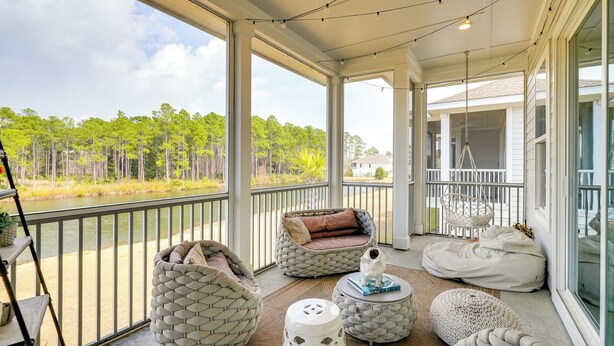 A covered outdoor area with large windows, a hammock, bean bags, and a small table with a decorative item. - 3 Mi to Ocean! Family-friendly 30A Getaway w/ Pool (Santa Rosa Beach)