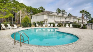 A swimming pool with lounge chairs, a building with a porch, and a fence. - 3 Mi to Ocean! Family-friendly 30A Getaway w/ Pool (Santa Rosa Beach)