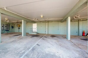 Un'ampia area interna caratterizzata da tubazioni a vista, pavimento in cemento e alcuni quadri elettrici.
