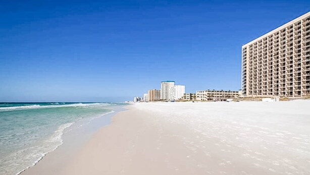 A beach with a large hotel building. - Beachfront Escape with Gulf Views, Pool & Hot Tub (Destin)