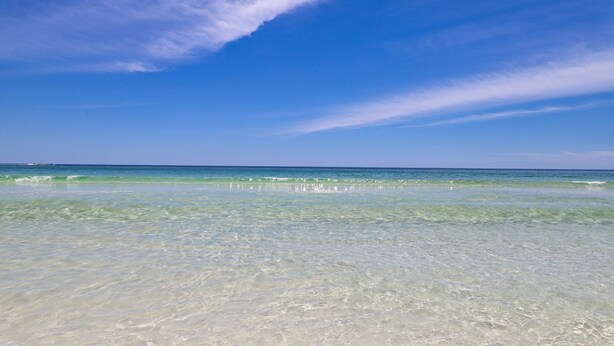 A beach with clear water and a blue sky. - Idyllic beach getaway w gulf views & swimming pool - beach access (Destin)