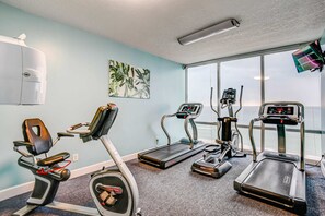 A gym with treadmills, an elliptical, and a stationary bike. - 17th Floor Oceanfront Condo with Shared Pool & Hot Tub, Ocean View, & Fast WiFi (Panama City Beach)