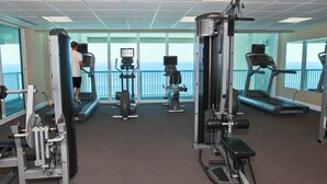 A gym with treadmills, weight machines, and exercise equipment. - Oceanfront condo with pool, hot tub & washer/dryer (Panama City Beach)