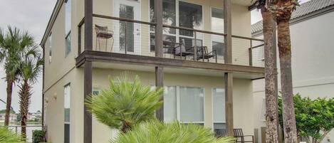 A two-story building with a balcony, palm trees, and a sign indicating 'Ocean Reef Destiny 6'.