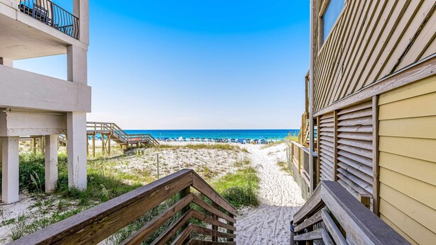 A staircase leading to a beach with a clear view of the ocean. - Casa Blanca (Destin)