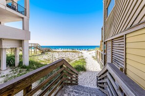 A staircase leading to a beach with a clear view of the ocean. - Casa Blanca (Destin)