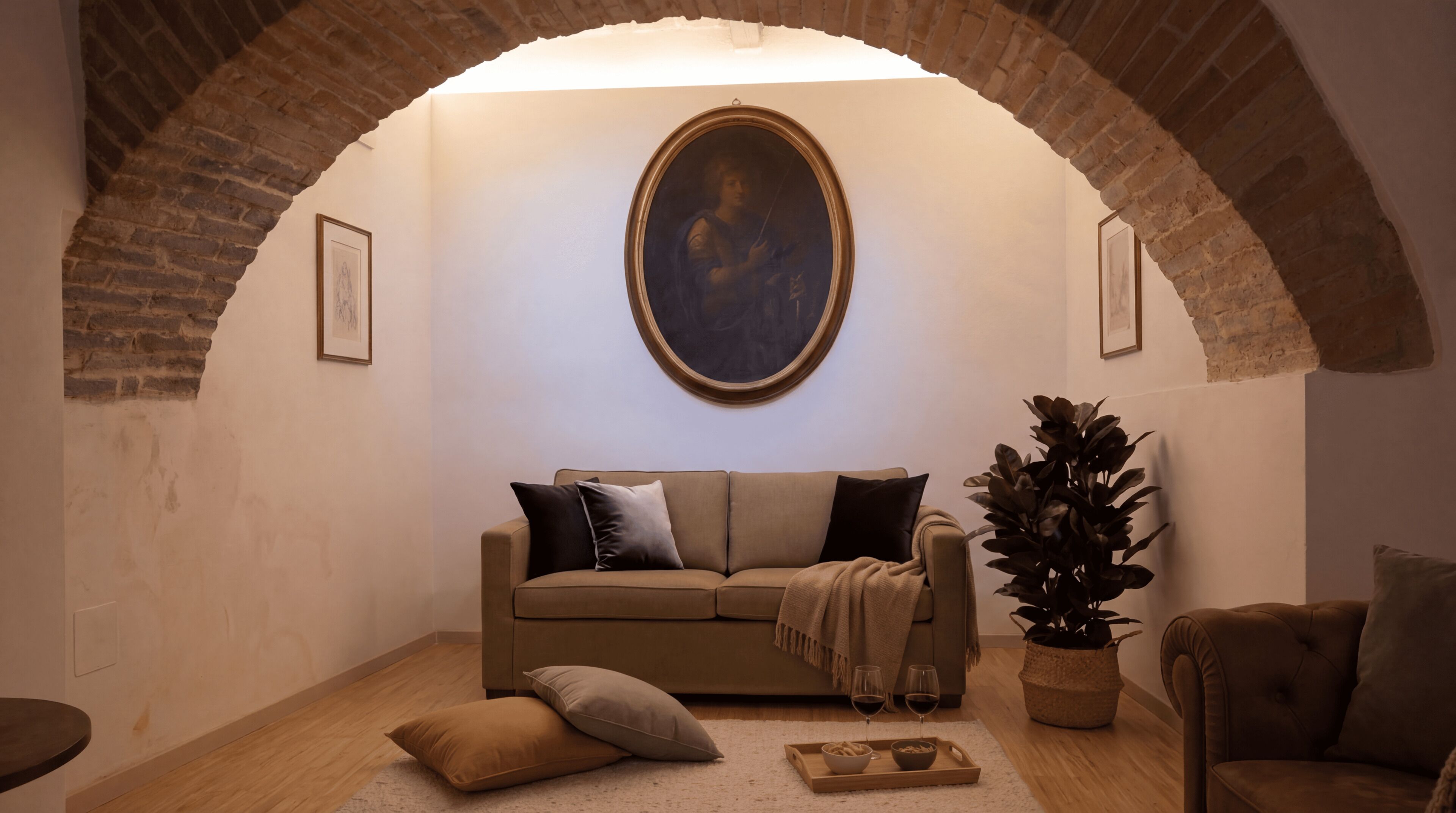 A cozy living room with a sofa, a potted plant, and a painting on the wall.