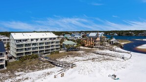 A coastal hotel with multiple floors, a beach access area, and a view of the sea. - Stylish oceanfront condo w/ pool access, private W/D, ocean views, & central AC (Santa Rosa Beach)