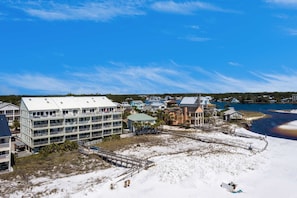 A coastal hotel with multiple floors, a beach access area, and a view of the sea. - Stylish oceanfront condo w/ pool access, private W/D, ocean views, & central AC (Santa Rosa Beach)