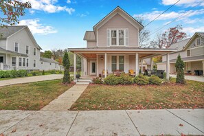 A two-story house with a front porch, a covered entryway, and a well-maintained lawn with fallen leaves. - Stay & Play in Ellicottville Village! Home w/ Deck (Ellicottville)