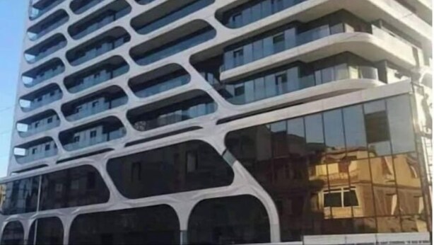 A modern high-rise building with a unique architectural design featuring curved balconies and large windows. - F2 high standings (Béjaïa)