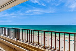 A balcony with a view of a beach and ocean. - Oceanview condo with pool, tennis courts, beach access, laundry, & balcony (Destin)