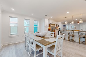 A modern kitchen with white cabinetry, a central island, and pendant lighting. - Gorgeous Dog-Friendly Home with Private W&D and Close to the Beach (Navarre)