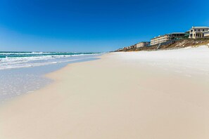 A beach with a row of buildings along the shore. - Updated, roomy Inlet Beach home with two outdoor decks and Shared Pool/Dock (Inlet Beach)