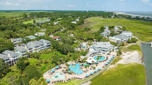A resort with multiple buildings, a large pool area, and a beach view. - Pet Friendly, Chef's Kitchen, Exercise Room - 1 Fiddlers Point (Fripp Island)