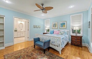 A bedroom with a bed, a chair, a nightstand, a ceiling fan, and a window with blinds. - Pet Friendly, Chef's Kitchen, Exercise Room - 1 Fiddlers Point (Fripp Island)