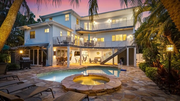 A two-story house with a pool, outdoor seating, and a hot tub. - Mangrove Mojito - Amazing Outdoor Space! (Anna Maria)
