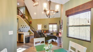 A spacious living area with a dining table, a staircase leading to an upper level, and a large window with blinds. - Blue Ridge Retreat: 1 Mi to Kingwood Golf (Clayton)