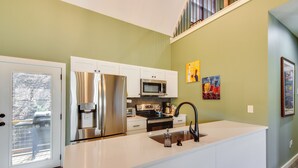 A modern kitchen with white cabinetry, stainless steel appliances, and a large island. - Blue Ridge Retreat: 1 Mi to Kingwood Golf (Clayton)