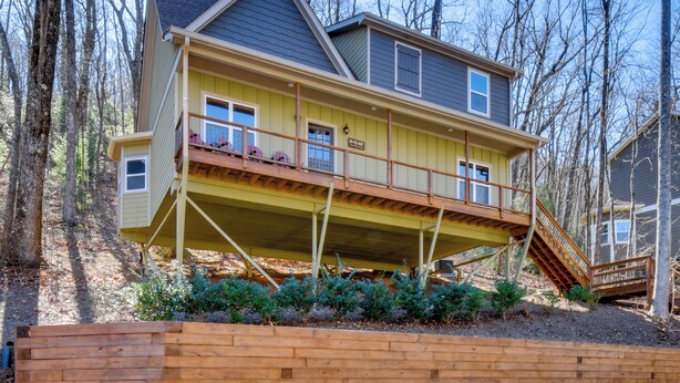 A two-story house with a wooden deck and a staircase leading to the upper floor. - Blue Ridge Retreat: 1 Mi to Kingwood Golf (Clayton)