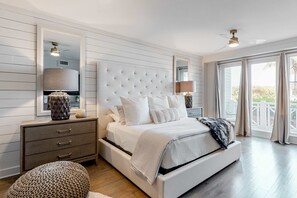 A bedroom with a large bed, a nightstand, a dresser, and a window with curtains. - Gorgeous, updated condo with balconies, pool, & great location near 30A (Alys Beach,)