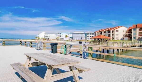 Outdoor dining - Water-view haven with sound-view balcony, shared pool, WiFi, and AC (Navarre Beach)