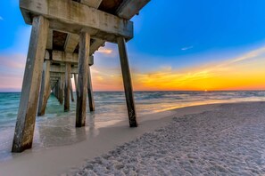 A pier extending into the ocean with a sunset in the background. - Dog-friendly duplex 2 blocks from beach with private yard, AC, & W&D (Panama City Beach)