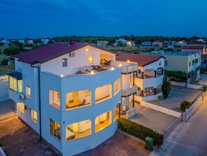 A multi-story residential building with balconies, large windows, and a paved driveway. - Apartment Lavaran 5 (Vir)