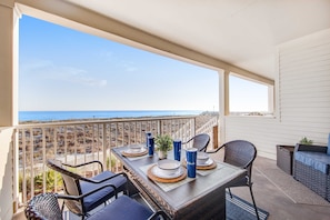 Outdoor dining - Blissful Coastal Condo with Shared Pool, Ocean View, Easy Beach Access & WiFi (Navarre Beach)