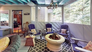 A cozy room with a fireplace, comfortable seating, and large windows. - Mountain Home Dog-friendly Getaway (Cashiers)