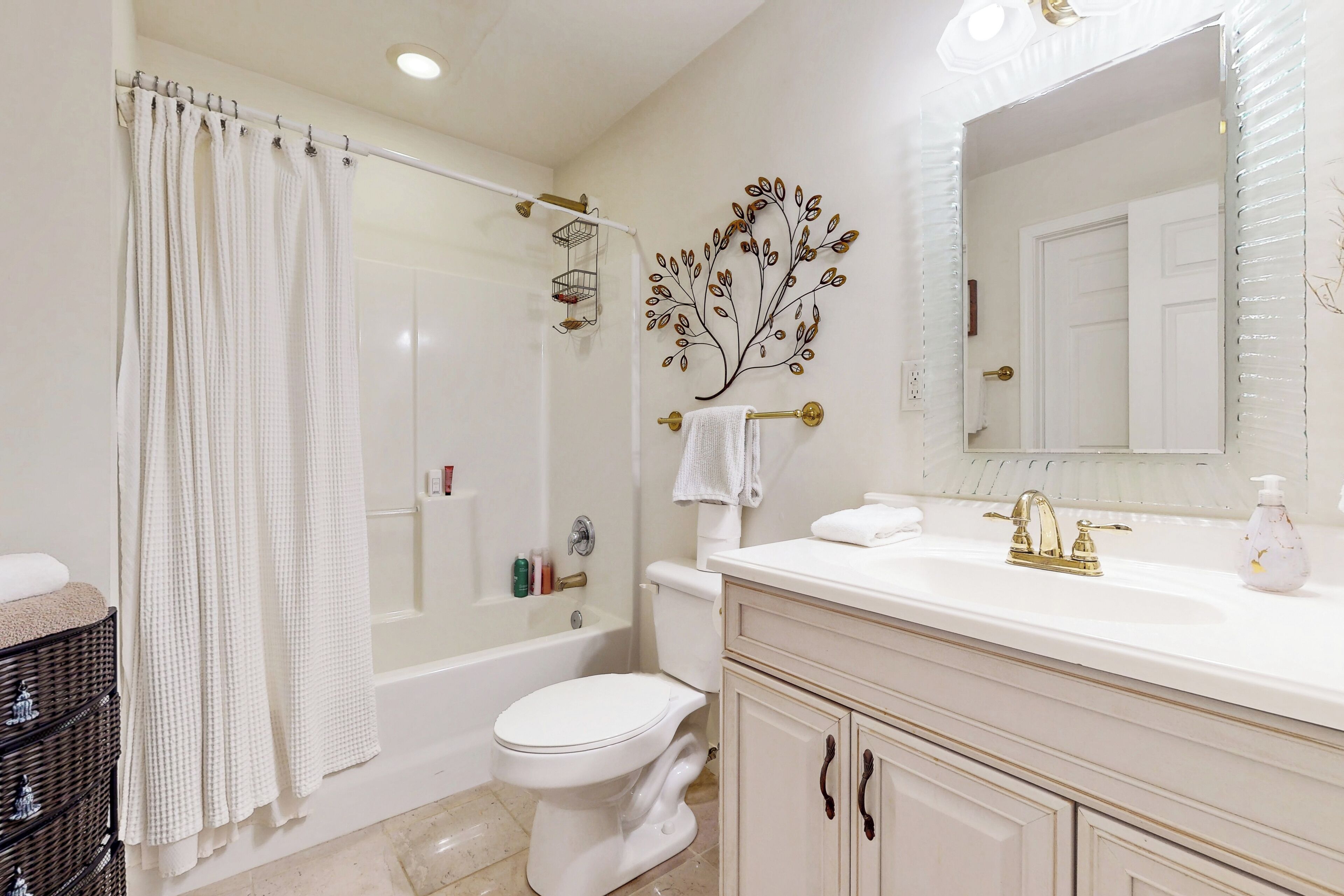 A bathroom with a bathtub, toilet, and sink.