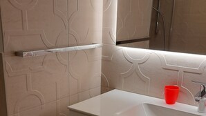A bathroom with a white vanity, a red cup, and a mirror. - Villa Konstanze Apartment with Mountain View, Private Terrace and Wi-Fi (Plan Da Tieja)